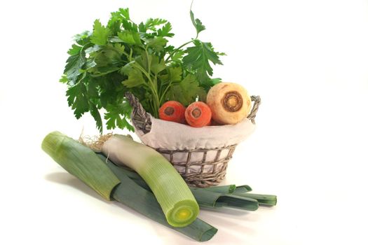 Greens with carrots, leek, parsley and parsley root in the basket