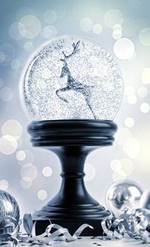 Snow globe with ornaments against a festive background