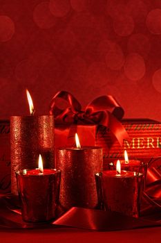 Christmas candles on a red vintage background 