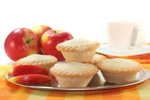 Apple pie on a silver platter in front of white background