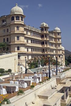 Open air restaurant and Rajput style palace (now a luxury hotel). Udaipur, Rajasthan, India.