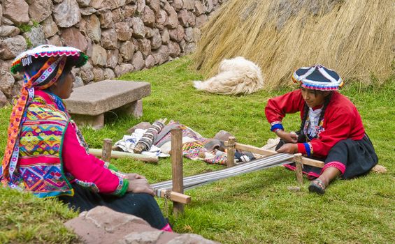 Cusco , Peru - May 26 2011 : Quechua Indian women weaving with strap loom