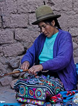 Cusco , Peru - May 26 2011 : Quechua Indian woman weaving with strap loom