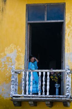 Catagena de Indias , Colombia - December 21 2010 : Girl in a balcony in  an old house 