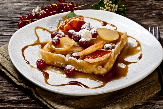 waffle with fruits,sugar and maple syrup