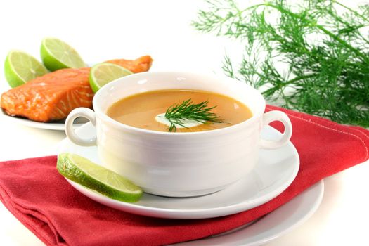 Salmon cream soup with a dollop of cream and dill