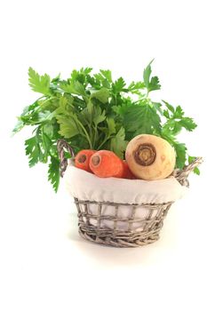 Greens with kohlrabi, carrots, leek, parsley and parsley root in the basket