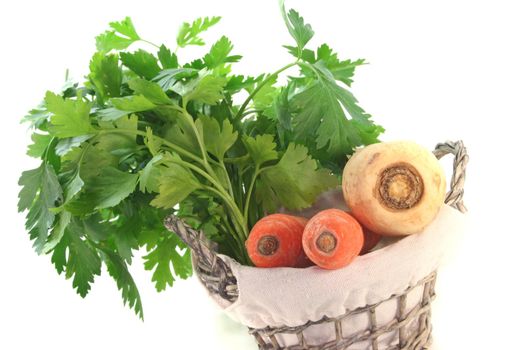 Greens with kohlrabi, carrots, leek, parsley and parsley root in the basket