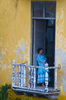 Catagena de Indias , Colombia - December 21 2010 : Girl in a balcony in  an old house 