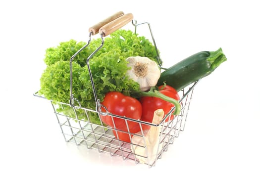 Colorful mixture of vegetables in the Shopping basket on a white background