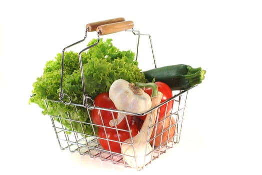 Colorful mixture of vegetables in the Shopping basket on a white background