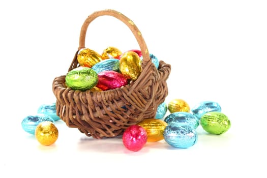 Easter basket with colorful Easter eggs on a white background