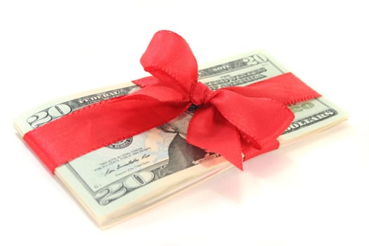 many dollar bills with a red ribbon on white background