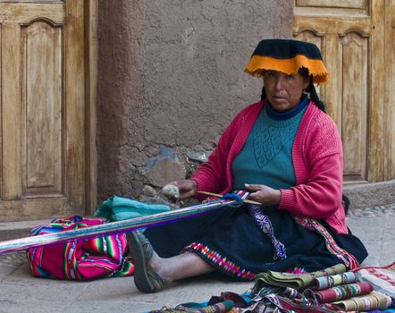 Cusco , Peru - May 26 2011 : Quechua Indian woman weaving with strap loom