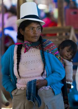 Cusco , Peru - May 28 2011 : Peruvian woman with here child in a market in Cusco Peru