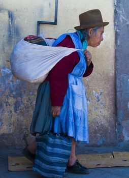 Cusco , Peru - May 31 :  Peruvian woman walk in the narrow alleys of  Cusco Peru 