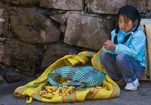 CUSCO , PERU - MAY 27  2011 : Pruvian girl in a local market 