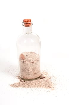 Shot of bottle with sand isolated on white