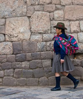 Cusco , Peru - May 25 :  Peruvian woman walk in the narrow alleys of  Cusco Peru 