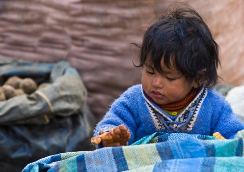 CUSCO , PERU - MAY 27  2011 : Pruvian child in a local market 