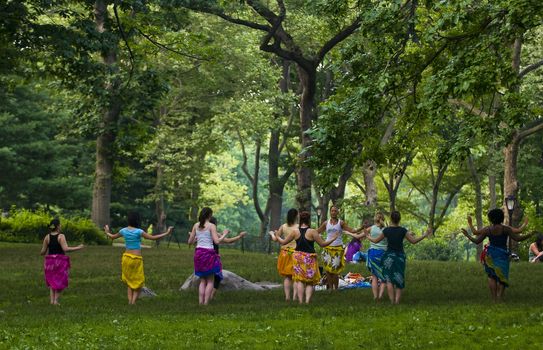 NEW YORK - JUNE 28 2011 : A group of women rehearse belly dancing in Cental park , Manhattan 