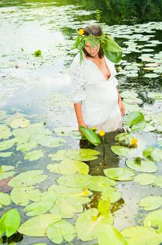 Portrait of young pregnant woman in traditional costume