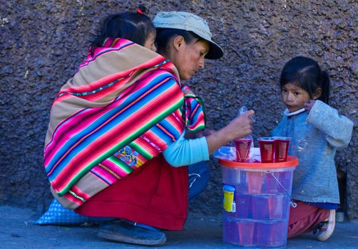 Cusco , Peru - May 28 2011 : Peruvian woman with here children in a market in Cusco Peru