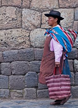 Cusco , Peru - May 25 :  Peruvian woman walk in the narrow alleys of  Cusco Peru 