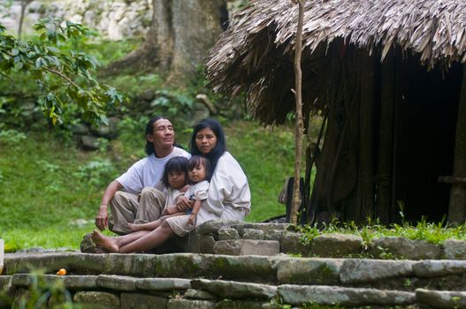 TAYRONA PARK , COLOMBIA - DECEMBER 17 2010 : Indian family sit together at home in a village in "Tayrona" park , Colombia 