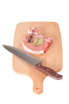 pork chop and knife on the cutting board 