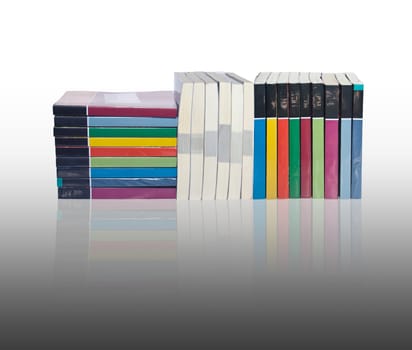Isolated stacks of colorful real books with reflection