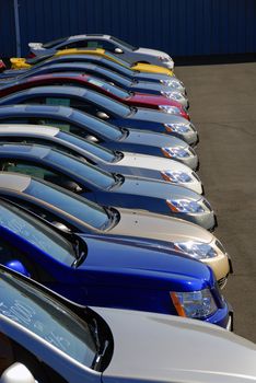 A row of new cars parked at a car dealer shop