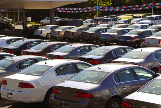 A row of new cars parked at a car dealer shop