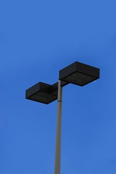 Street lights isolated against a clear blue sky