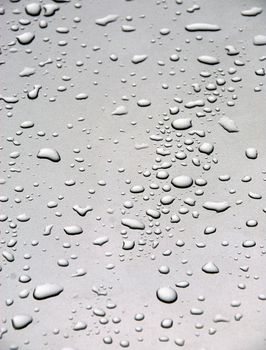 Rain drops on a gray metallic back ground