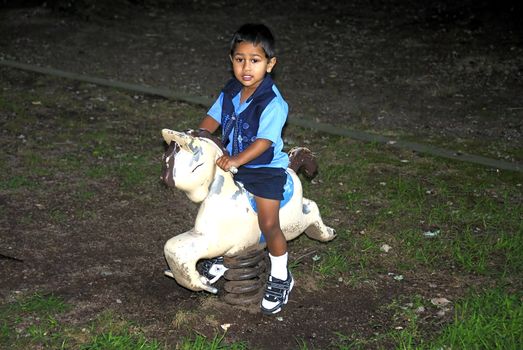 A young handsome kid playing at a local park