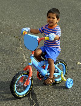 An handsome Indian kid enjoying his bike