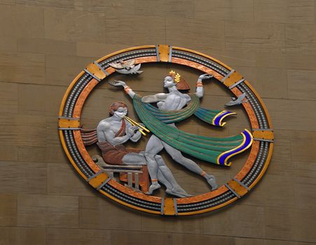 Art Deco frieze on a granite wall at Rockefeller Center in New York City.