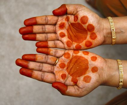a design on hands against a natural back ground