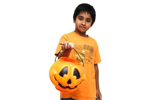 An handsome Indian child holding a candy cart for trick or treat