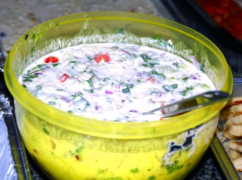 A freshly home made salad with yogurt onions and tomato