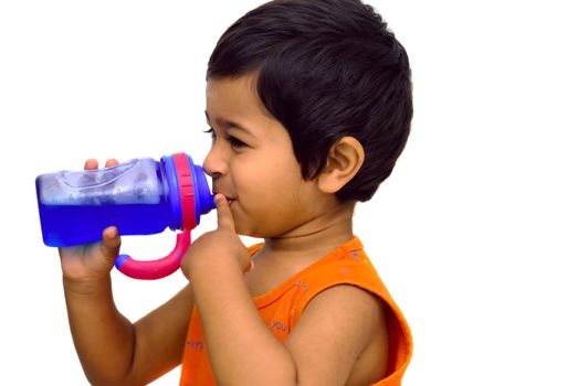 An handsome indian kid having fun drinking juice