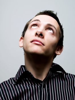 Portrait of a young man looking up