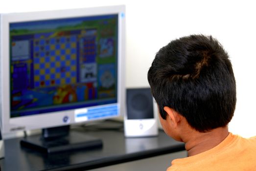An young kid playing games at the internet