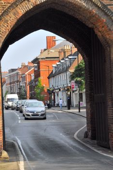 Old gate is very well framing view of a market town.