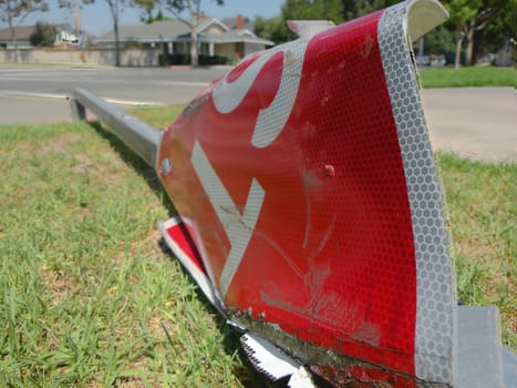 a fallen stop sign next to a neighborhood street. a victim of an accident.