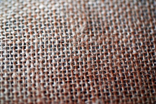 A background photograph, consisting of a close-up of jute fabric.