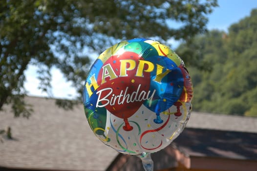 a mylar happy birthday ballon at a party