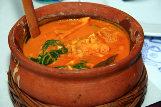 asian peanut stew served in a clay pot
