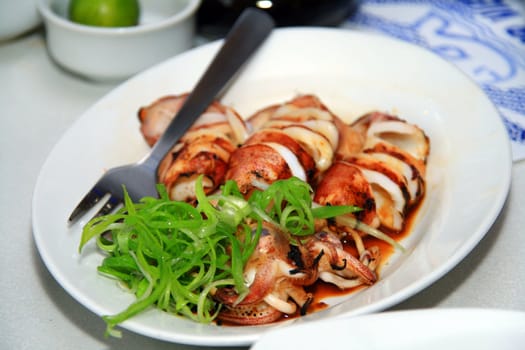 chopped grilled squid served in a dish
